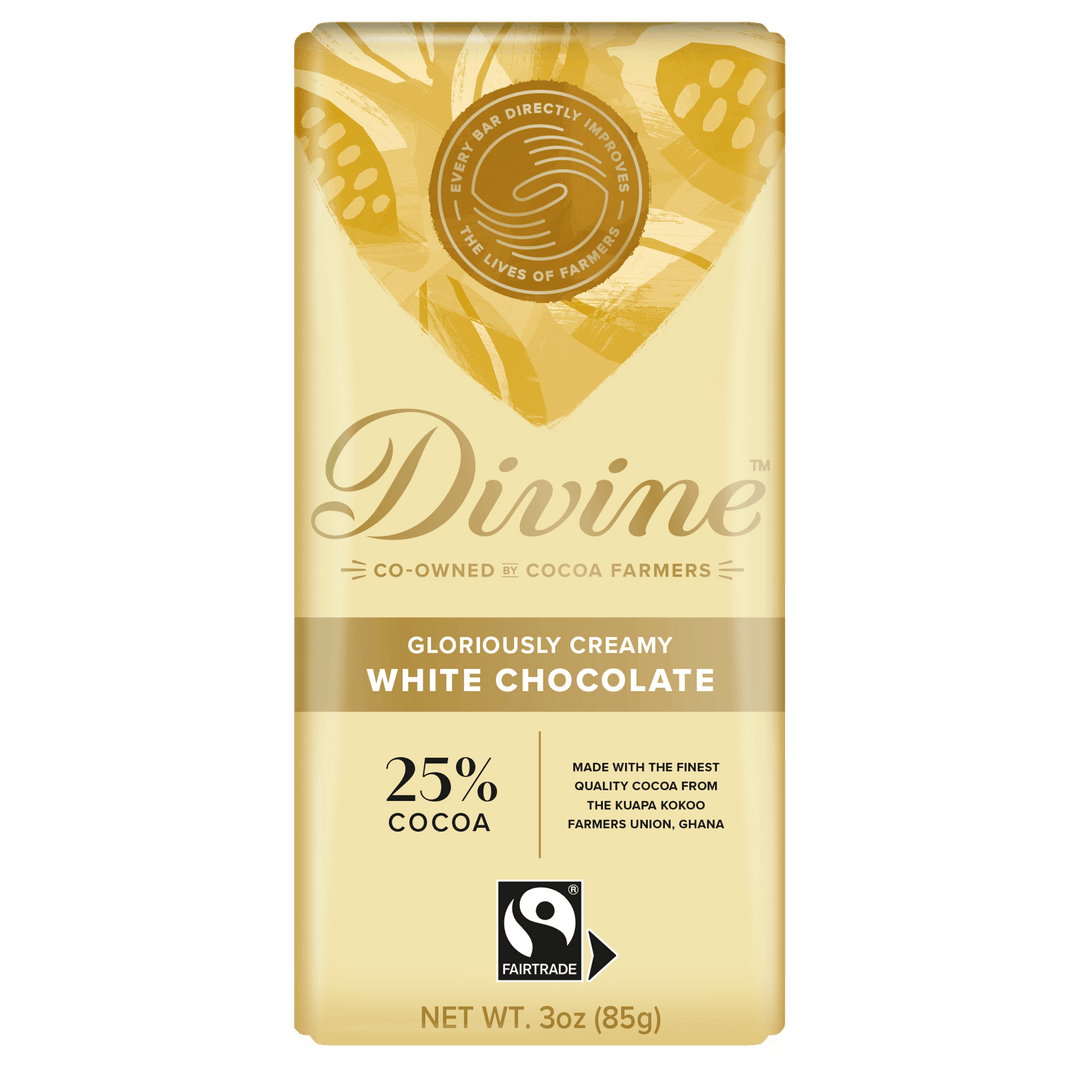 A 3 oz bar of Divine White Chocolate, 25% cocoa, in its original packaging. The packaging is a pale cream/beige color with gold leaf patterns and features the Divine brand logo and a Fairtrade certification mark.