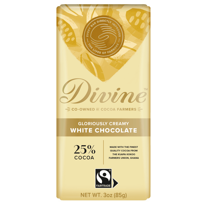A 3 oz bar of Divine White Chocolate, 25% cocoa, in its original packaging. The packaging is a pale cream/beige color with gold leaf patterns and features the Divine brand logo and a Fairtrade certification mark.