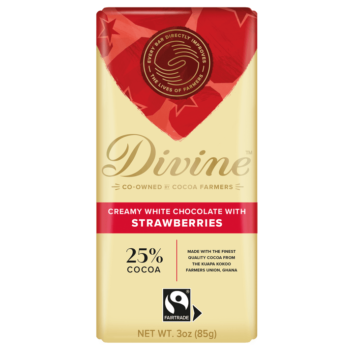 A 3 oz Divine brand chocolate bar wrapper for 'Creamy White Chocolate with Strawberries' on a plain white background. The wrapper is cream-colored with a red heart-shaped graphic at the top, featuring the Divine logo and a Fairtrade certification logo.