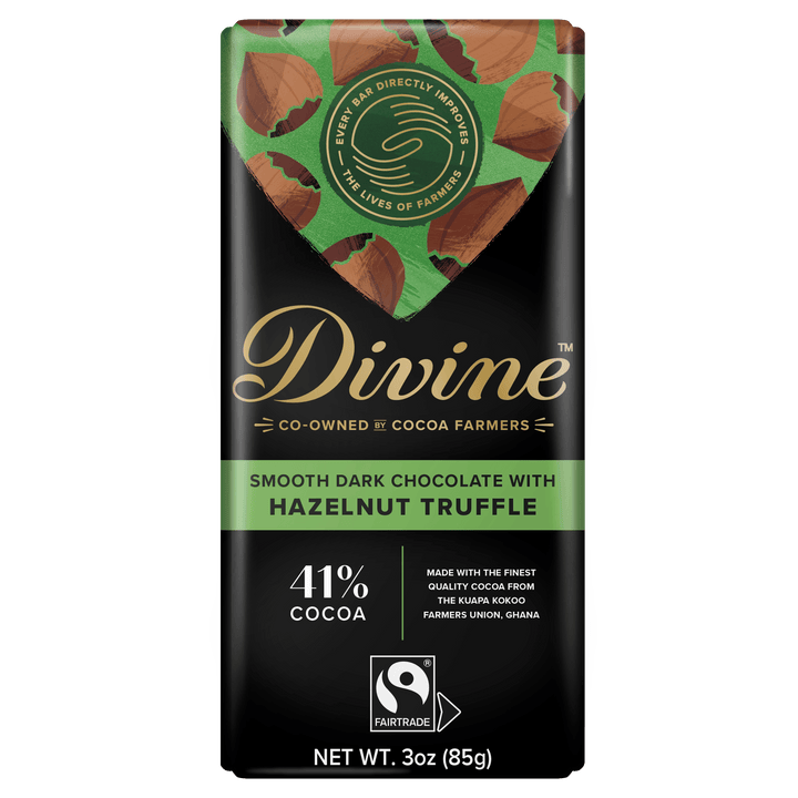 Divine Cocoa Fairtrade chocolate bar with hazelnut truffle flavor, featuring a black wrapper with green and gold accents and a Fairtrade logo.