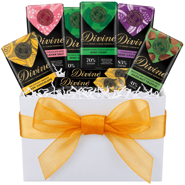A Divine Divin chocolate gift box set featuring multiple chocolate bars in assorted flavors arranged inside a white gift box with a large orange-gold ribbon bow.