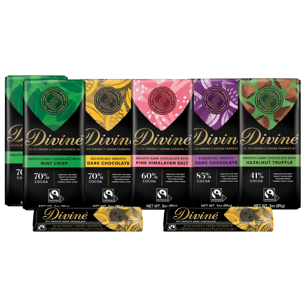 Six Divine brand chocolate bars in assorted flavors lined up on a white background, with two additional wrapped bars in front. The packaging features colorful flavor-specific graphics in green, yellow, pink, purple, and red, with black lower sections and gold Divine branding.