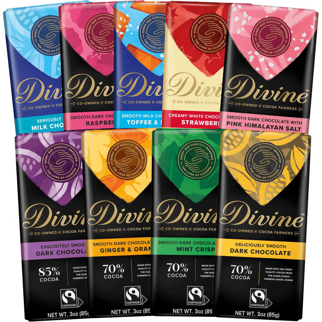 Eight Divine cocoa bars in assorted flavors arranged in two rows on a black background. The packaging shows the brand name 'Divine' prominently in gold script, with colorful flavor panels and dark chocolate bars visible.